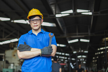 portrait image asian engineer men wearing uniform safety and holding wrench tool in factory.  male professional maintenance repair machine at industrial.