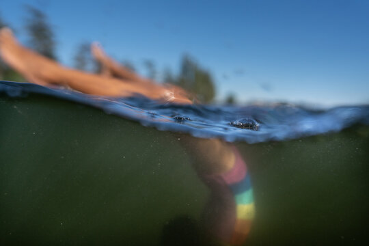 Soft focus spilt images of girl doing handstand in murky water