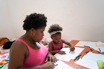 Daughter And Mother Drawing On The Table.