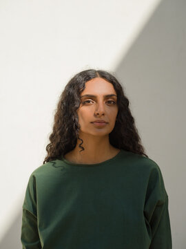 portrait of woman with diagonal shadow with white background