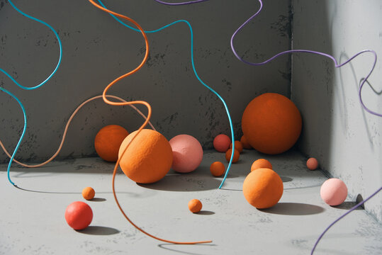 Abstract composition of objects: balls and cords on a gray background