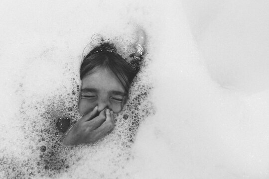 black and white photo fo child in bubbles