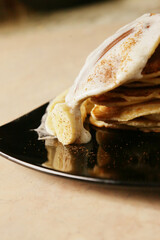 Homemade tasty panckes with white ice-cream and bananas