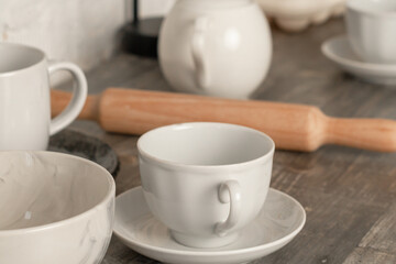 Fototapeta na wymiar cups, kitchen utensils, rolling pin, on the kitchen table