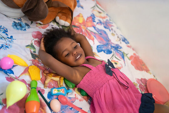 Little Black Girl Lying On The Bed.