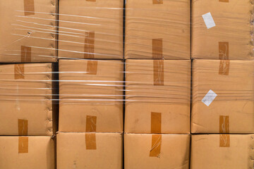A stock photo close up of cardboard packages wrapped in the protective foil