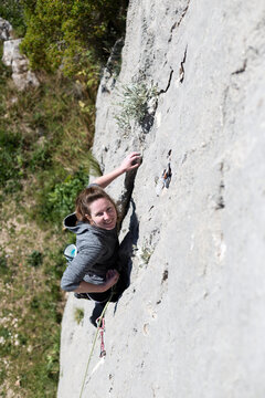Adventurous Woman Rock Climbing Outdoors
