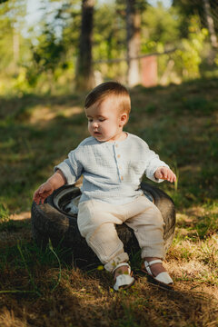 Lovely boy in muslin in forest.