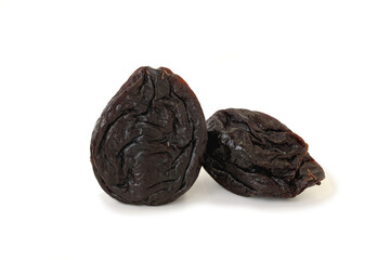 Two dried prunes isolated on white