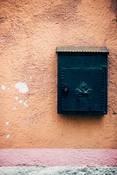 Green mailbox on orange wall