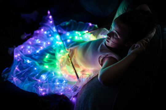 Girl with light-up LED wing costume shot from high angle