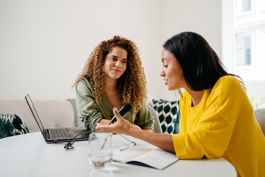 Ethnic women recording podcast together