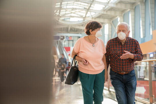 Senior Couple Wearing Masks At Shopping Mall