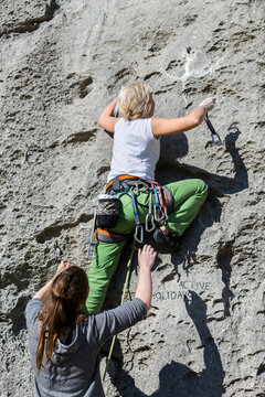 Adventurous Woman Rock Climbing Outdoors