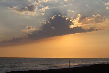 sunset behind the cloud