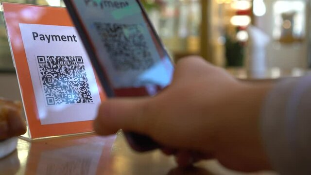 QR code payment in the restaurant. Contactless payment method where payment is performed by scanning a QR code from a mobile app