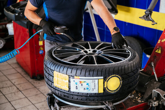 Man changing tire on wheel