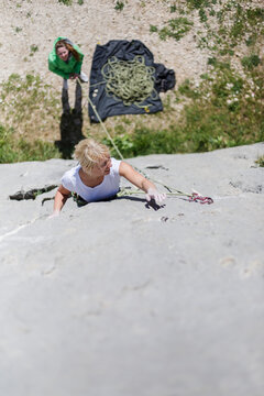 Adventurous Woman Rock Climbing Outdoors