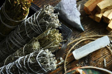 A close up image of sage smudge bundles and selenite wand. 