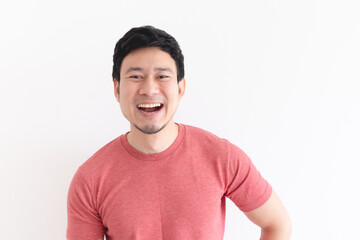 Enjoy and laughing face of Asian man in red t-shirt on isolated background.