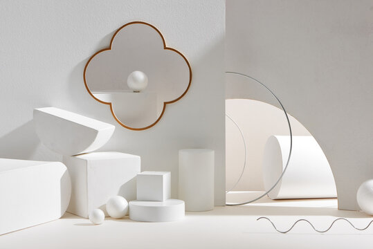 Abstract white equilibrium still life installation with primitive geometric shapes.