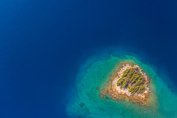 aerial view if tiny island in turquoise sea