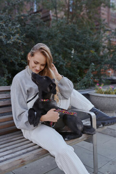 modern woman with black dog puppy