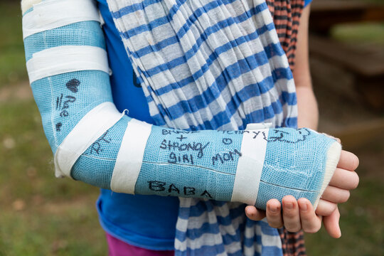 Young Girl With Cast On Broken Arm And Family Signatures