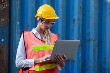 woman working with laptop in cargo container. Containers box from Cargo freight ship for import export. Business logistic concept, Import and export concept