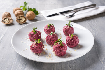 Georgian beetroot phali or pkhali with walnuts, garlic and spices on white plate