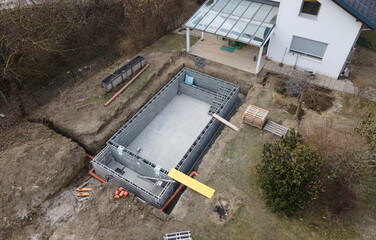 Drones aerial photo of a construction site of a pool, formwork concrete blocks already finished and...