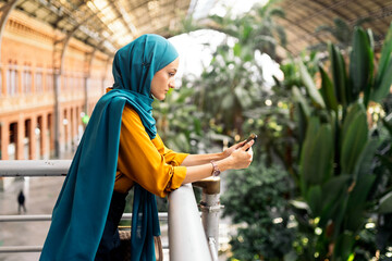 Muslim Woman Using Phone