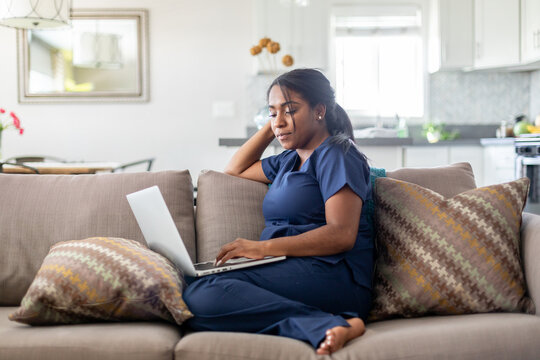 Woman Focuses On Her Computer On the Couch