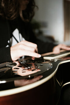 Playing a dobro guitar at home