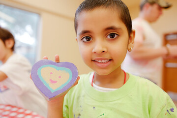 Happy and beautiful short hair preschool age girl enjoying different children retreat activities...