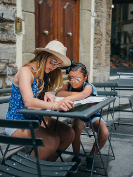 Mother and daughter looking at a map to visit sites throughout Florence