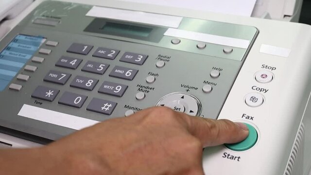 hand man are using a fax machine in the office, equipment for data transmission