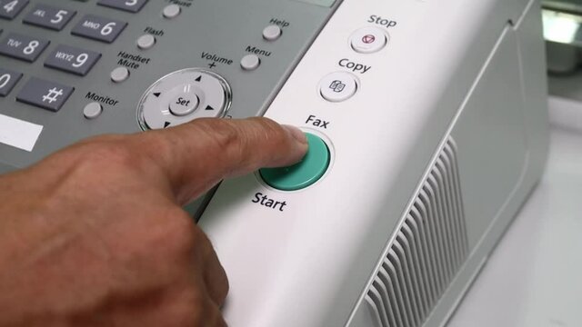 hand man are using a fax machine in the office, equipment for data transmission