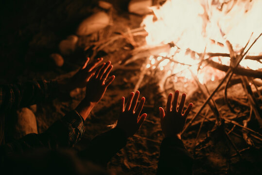 Hands warm by the campfire