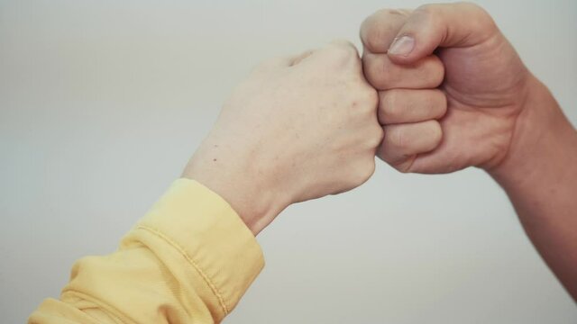 social distance. teamwork. fist to fist commit a respect and brotherhood gesture. business team hands fists. people of different skin colors partnership friendship teamwork social distance solidarity