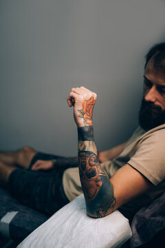 Hand of a young man with colorful tattoos