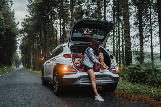Woman tying her shoes in the car