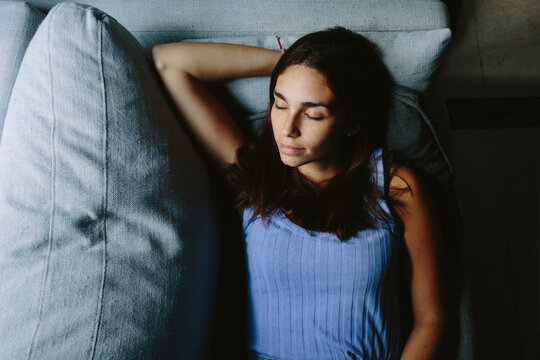 Young woman taking a nap on the couch
