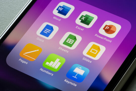 Portland, OR, USA - Mar 15, 2021: Office suites of apps created by Microsoft, Google, and Apple are seen on an iPhone - Word, Excel, PowerPoint, Docs, Sheets, Slides, Pages, Numbers, and Keynotes.