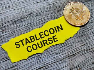 Digital currency concept. Selective focus image with noise effect phrase STABLE COIN COURSE written on sticky note with bitcoin.