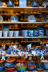 Fototapeta na wymiar Variety of traditional colorful handcrafted ceramics on shelves of souvenir shop in Istanbul, Turkey