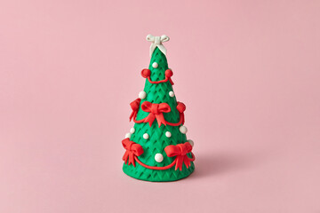 Handcraft figure of Christmas tree from modeling clay.