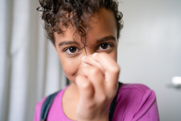 Closeup of girl pulling down short curl