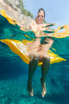 Woman relaxing on a lilo cooling her feet