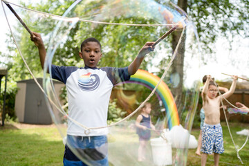 Black boy making huge bubbles
